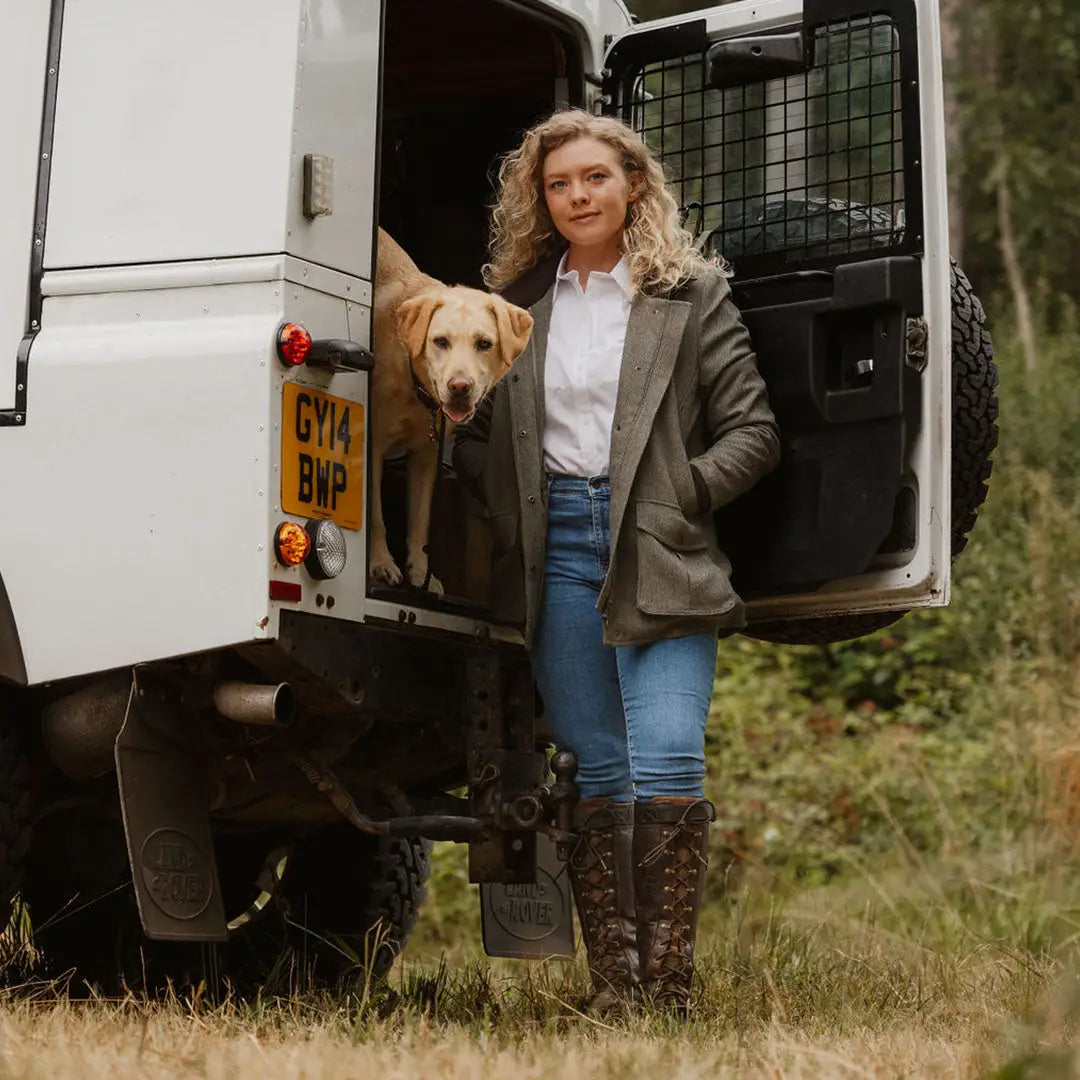 White van with open door as a person and dog exit, showcasing New Forest Tweed Field Coat