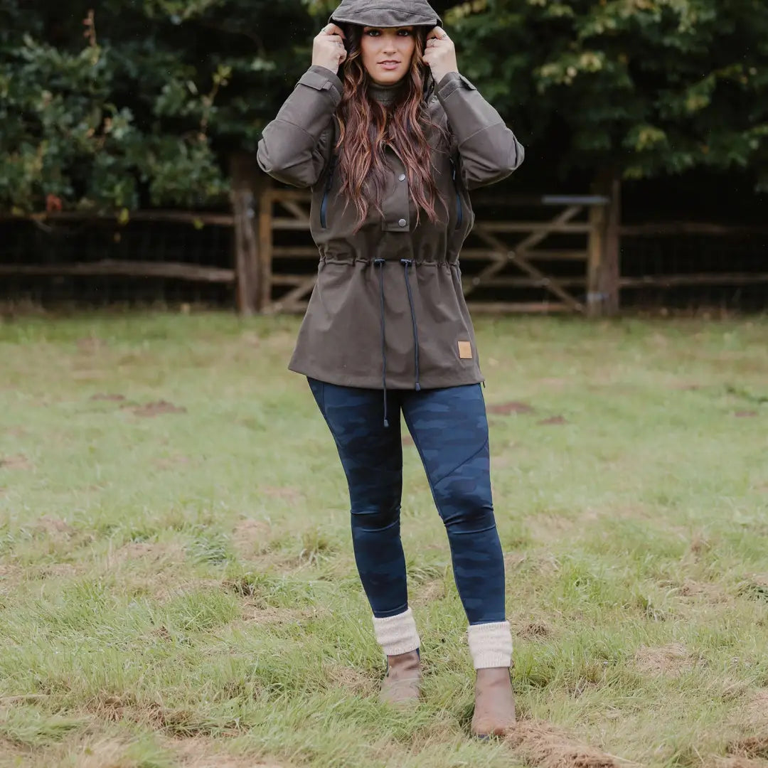 Woman in a gray jacket and flat cap rocking the New Forest Country Sport Smock outdoors