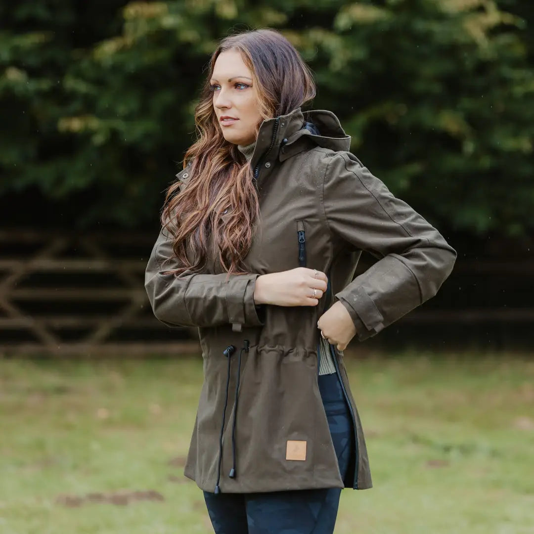 Olive green country sport smock jacket with drawstring waist on a stylish woman