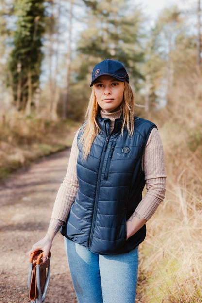 Woman in a navy puffer vest showcasing the New Forest Ladies Heated Gilet