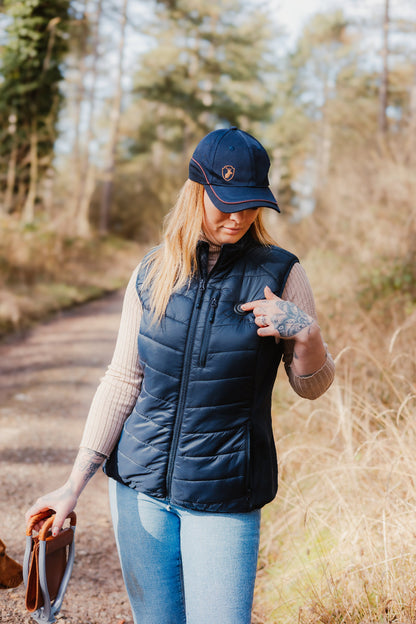 Woman’s navy blue puffer vest featuring the New Forest Ladies Heated Gilet design