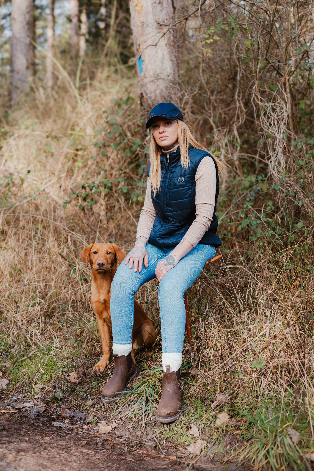 Woman in outdoor gear with dog wearing a stylish New Forest heated gilet