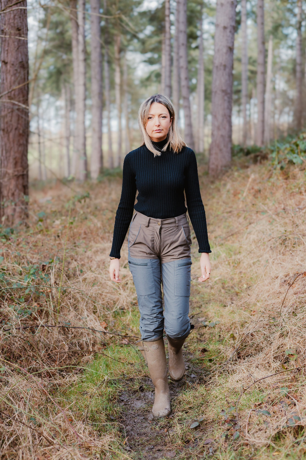 Woman in outdoor attire wearing Forest Nightjar Trousers, perfect for adventures