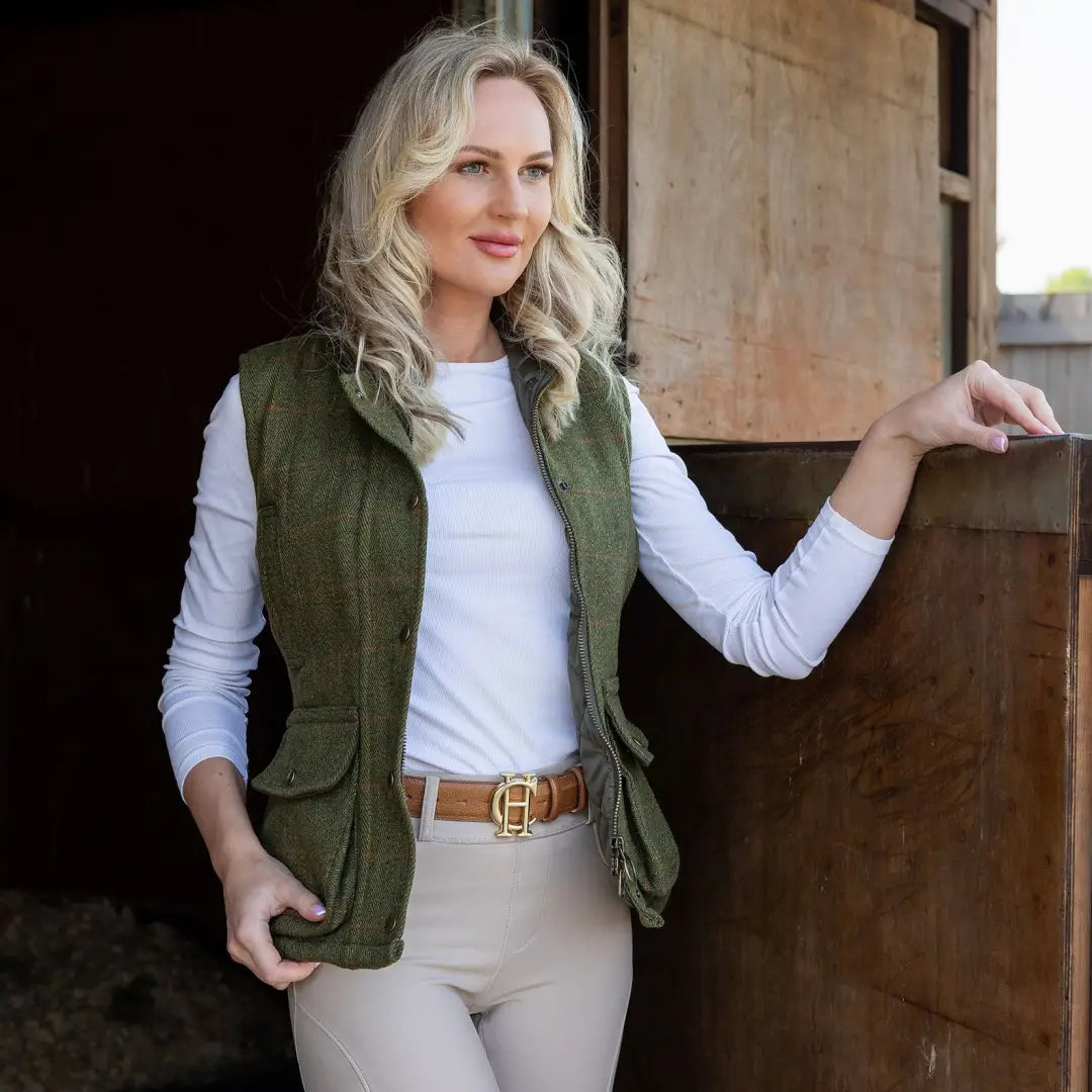 Woman in a green quilted vest, styling the New Forest Ladies Tweed Gilet