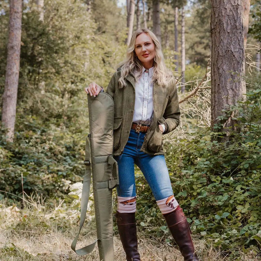 Woman in a forest wearing a stylish Ladies Tweed Jacket, perfect for outdoor adventures