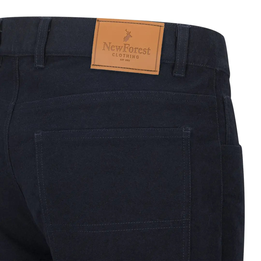 Dark blue Forest Moleskin Jeans with a stylish leather brand patch on the waistband