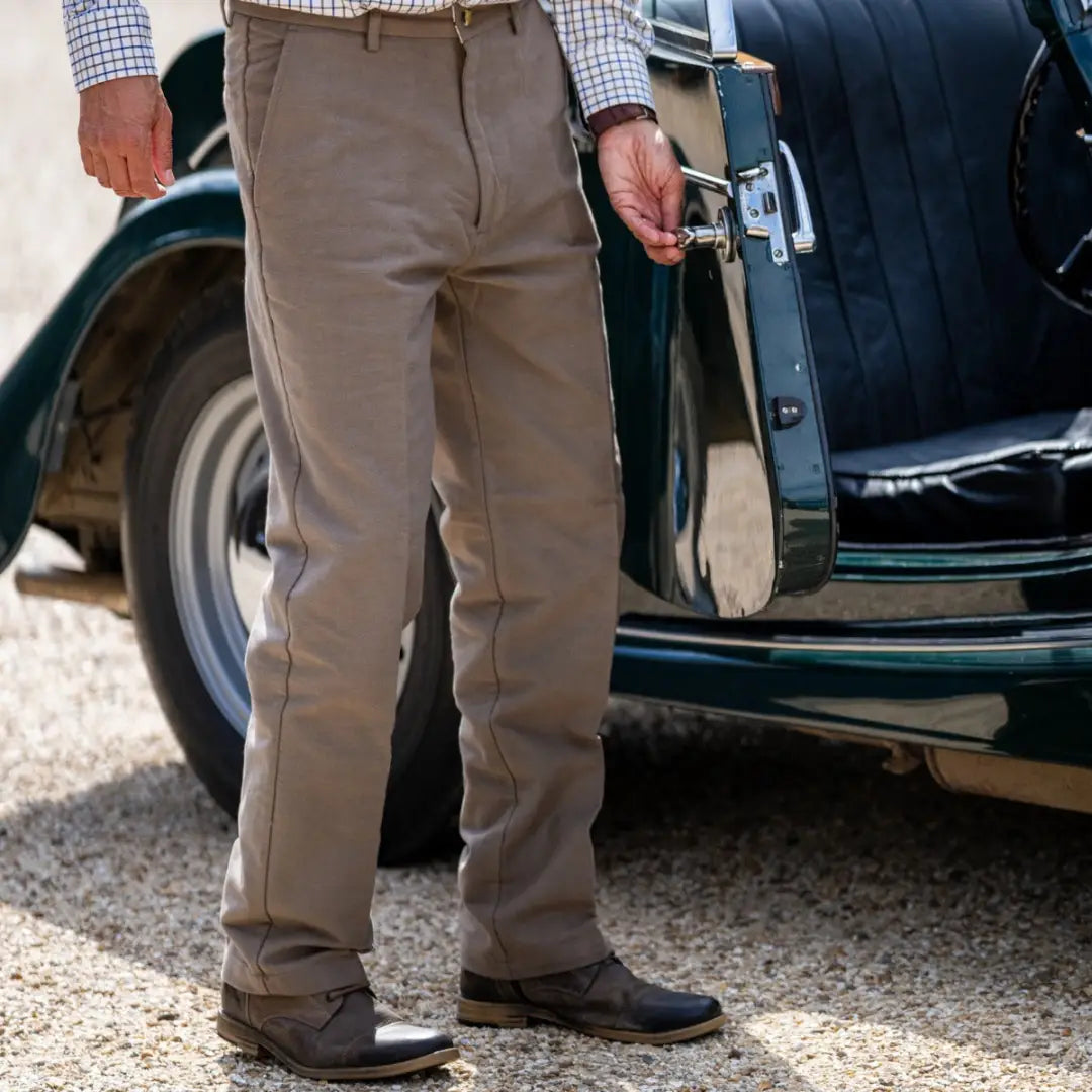 Person in New Forest Moleskin Trousers standing beside a stylish car