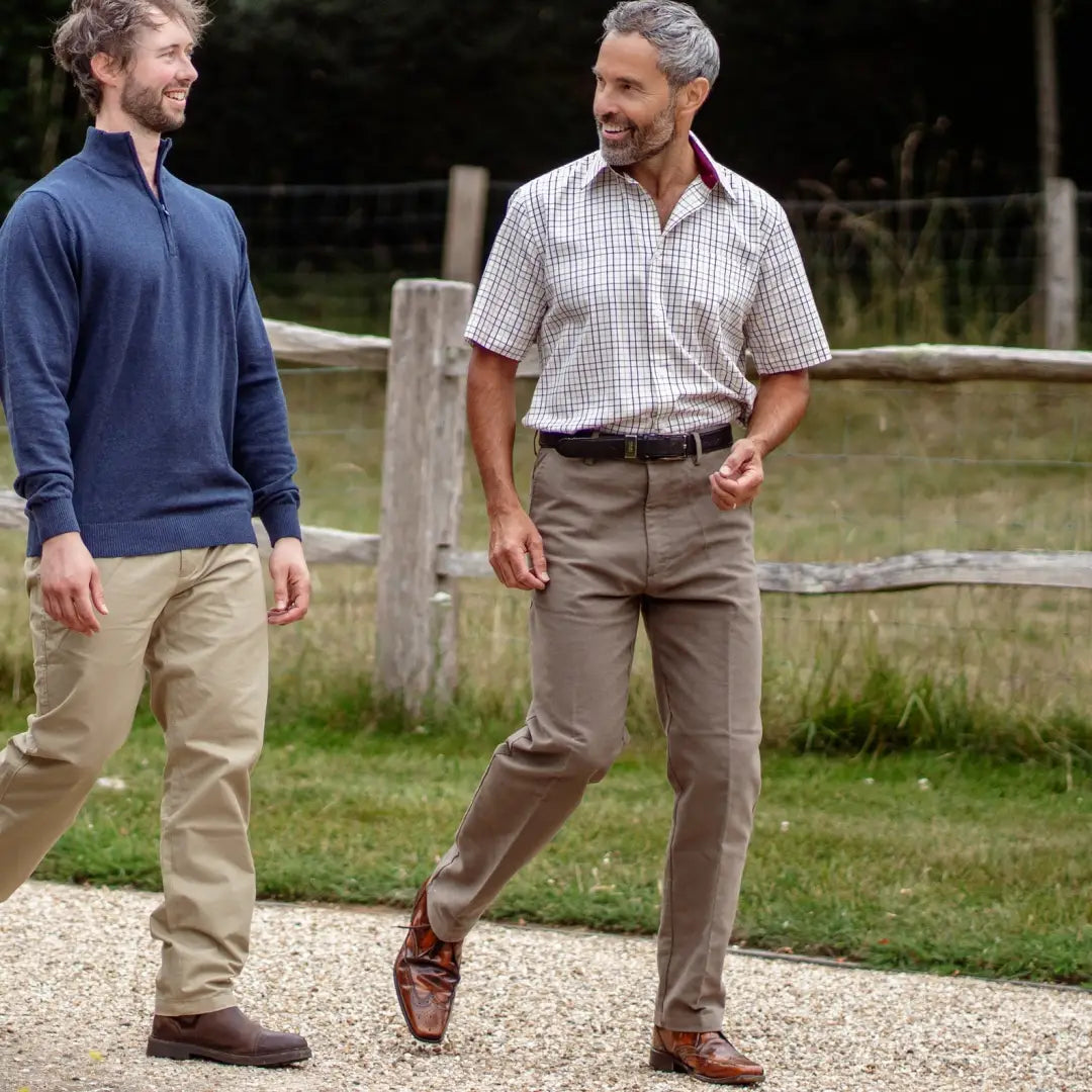 Two men in Forest Moleskin Trousers enjoying a chat outdoors together