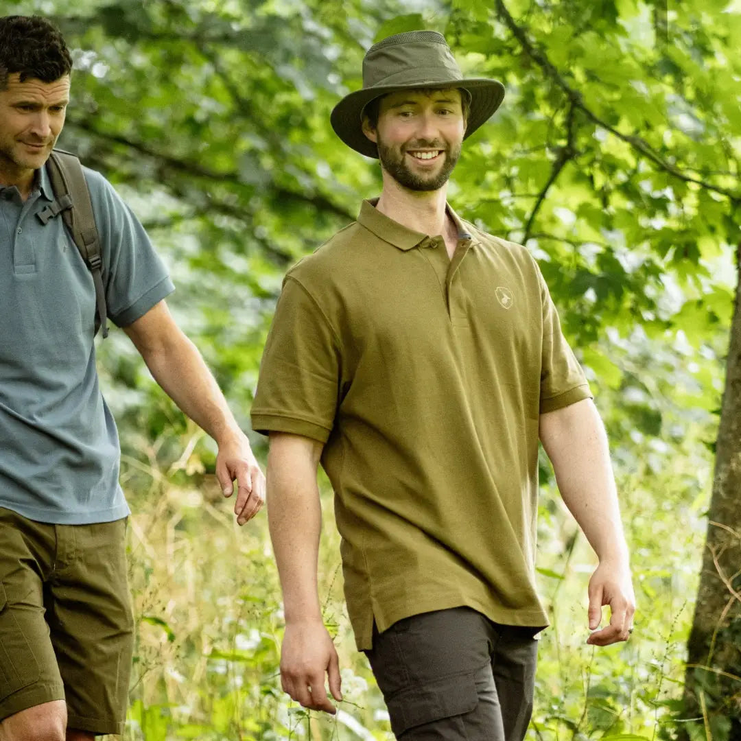 Two men wearing a stylish Forest Pique Polo Shirt on a nature trail