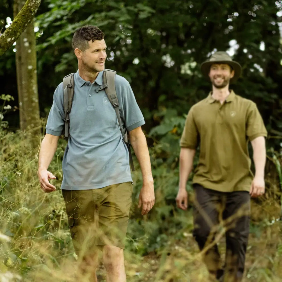 Two men in a forest wearing stylish New Forest Pique Polo Shirts