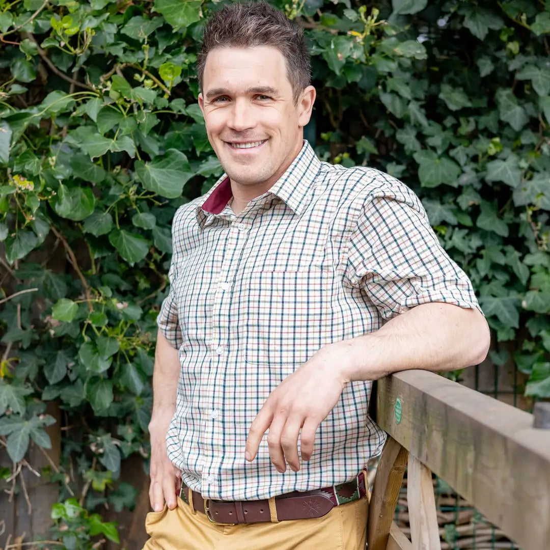 Smiling man in checkered short sleeve shirt showcasing New Forest country clothing