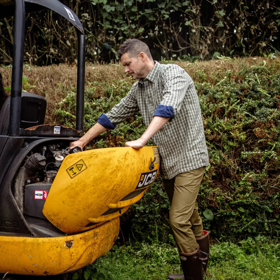 Yellow mini-dumper in a garden, perfect for pairing with New Forest Premium Fleece Lined Shirt