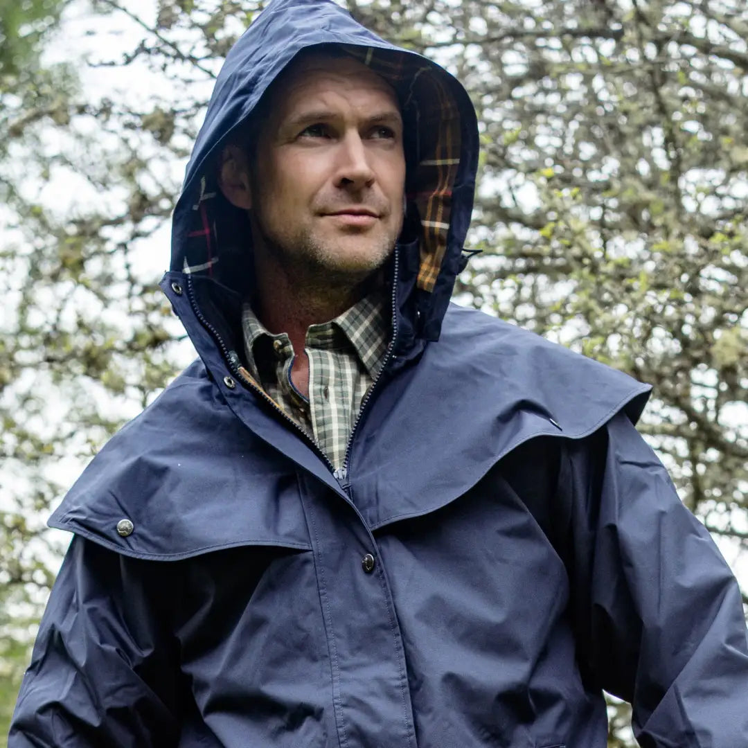 Navy blue hooded rain jacket for men in outdoors, perfect country clothing for hunting