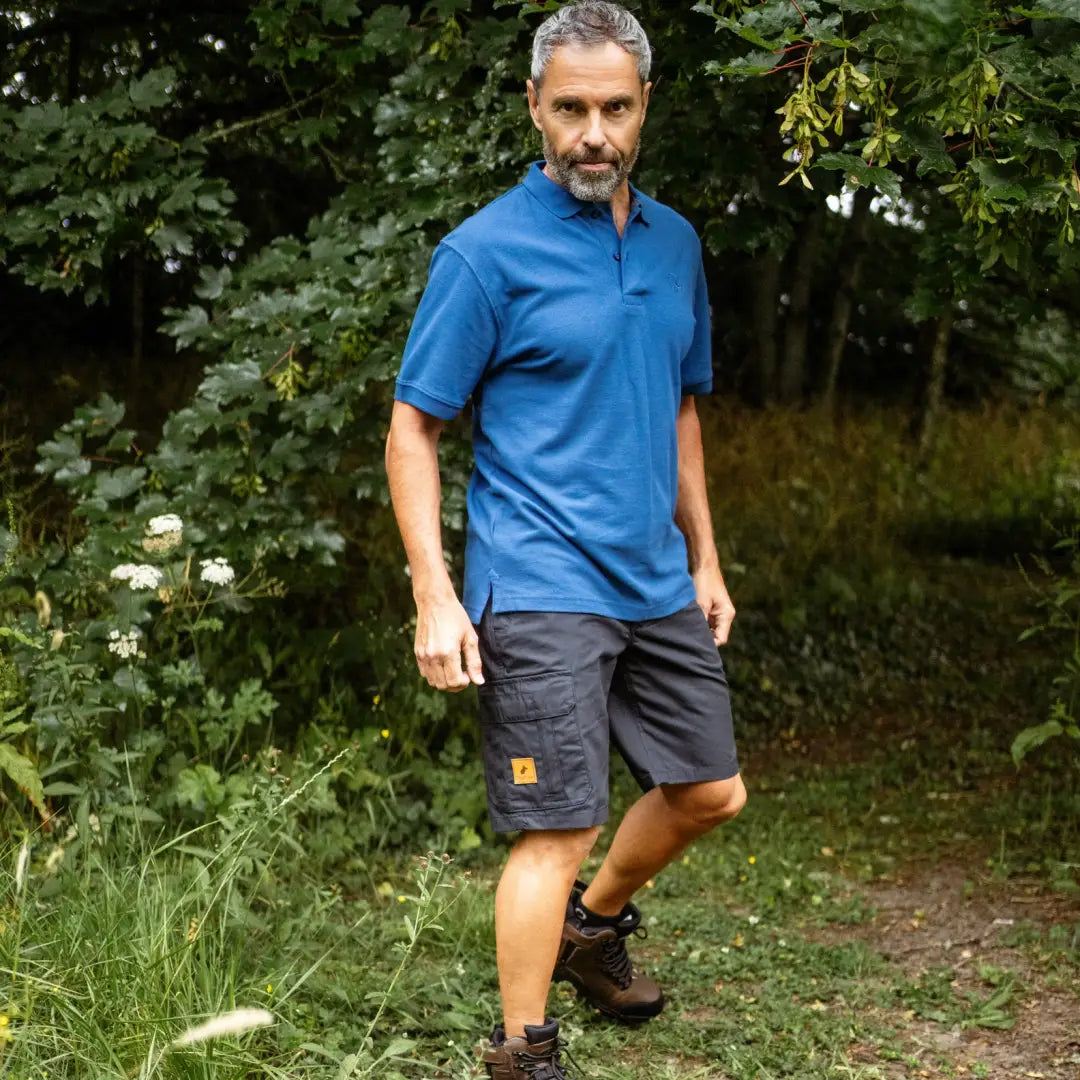 Middle-aged man in blue polo, dark shorts showcasing New Forest Trail Shorts