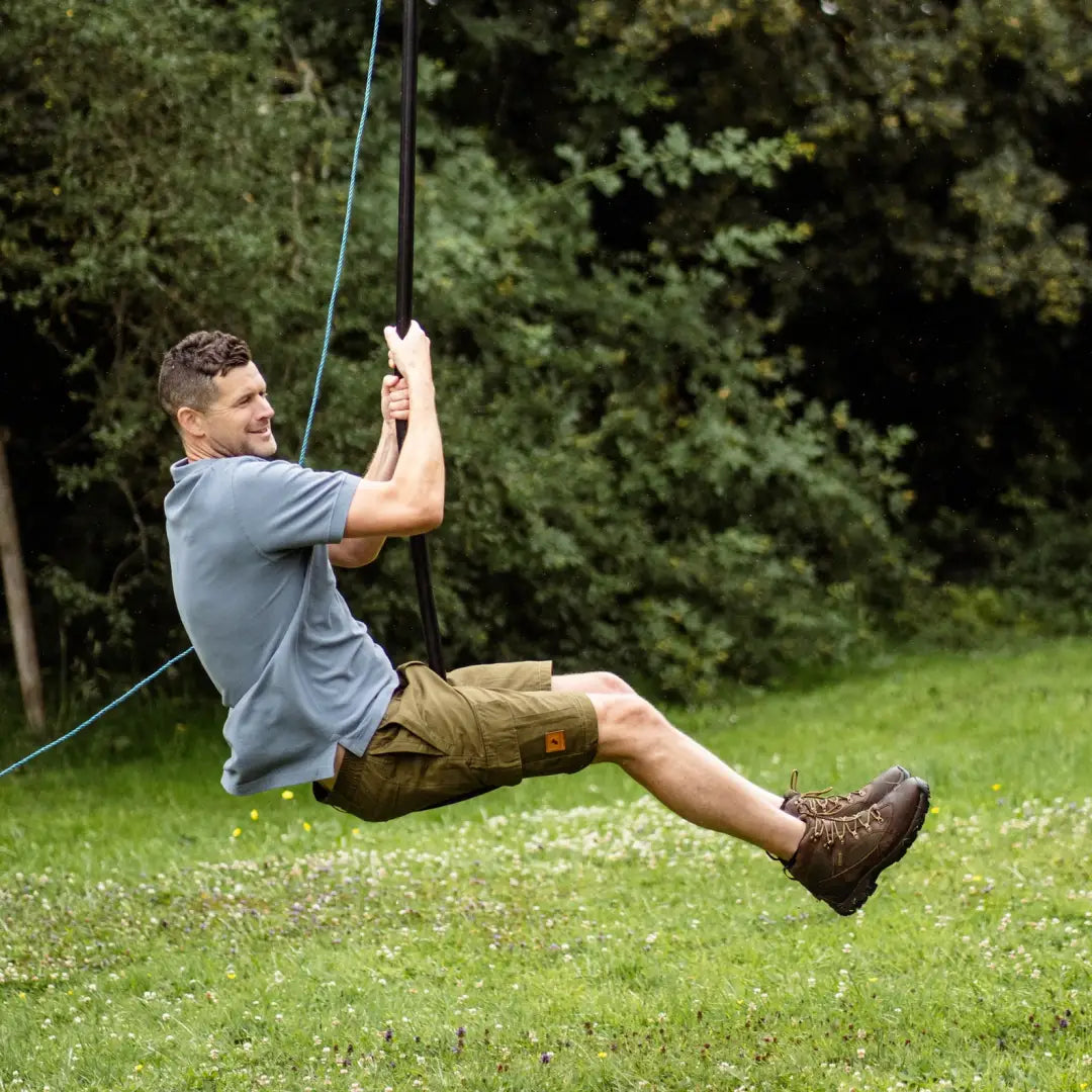 Man enjoying a rope swing outdoors in stylish Forest Trail Shorts