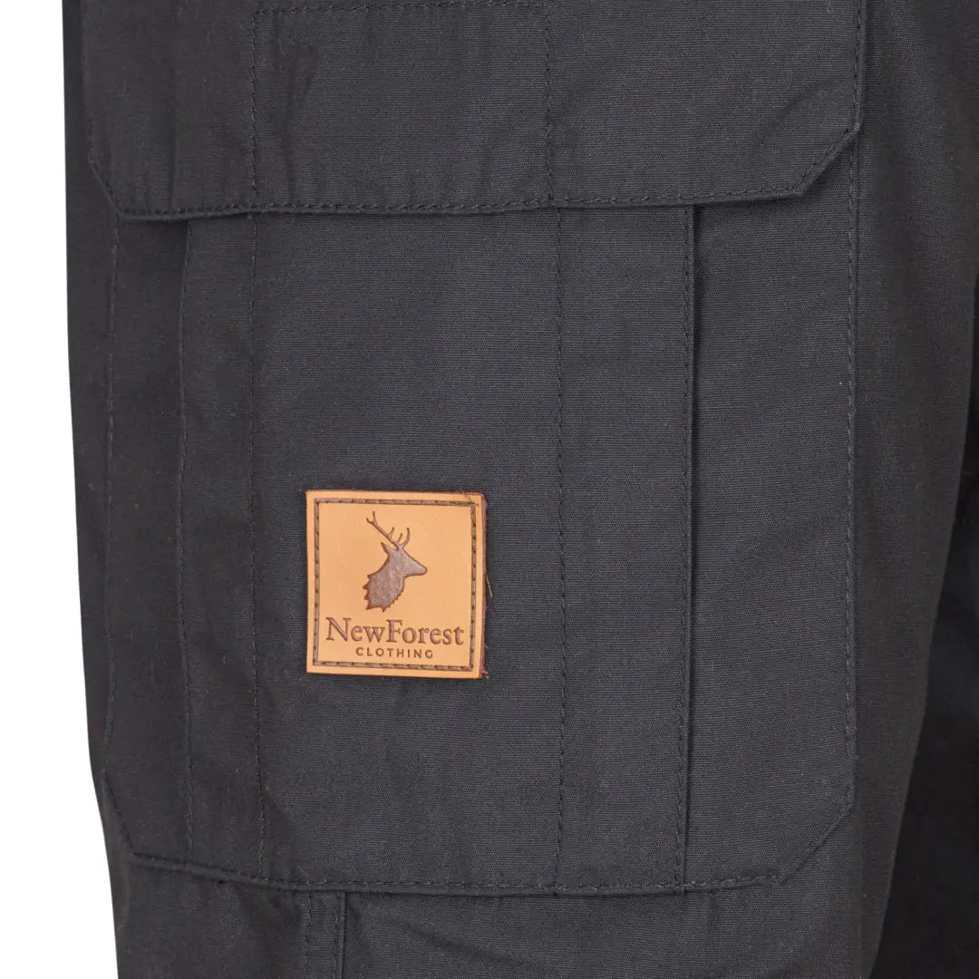 Dark gray cargo pocket on New Forest Trail Trousers with deer logo leather patch