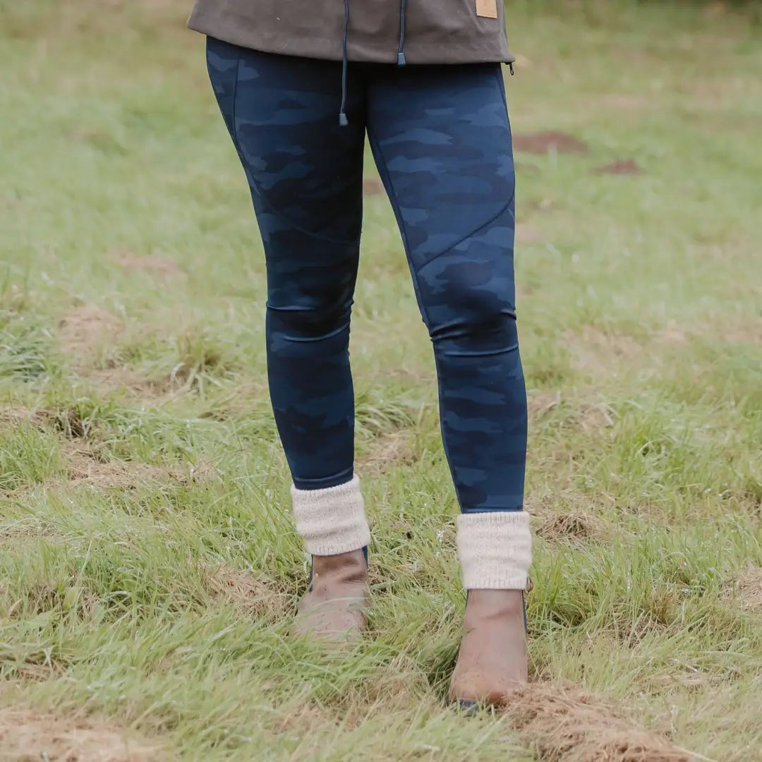 Pair of legs in blue jeans and brown boots showcasing New Forest Trek Leggings on grass