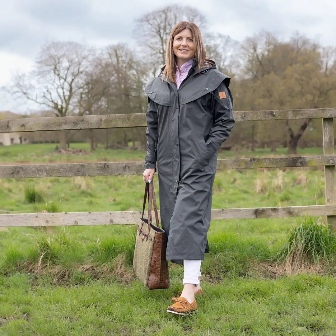 Person in rural setting wearing the New Forest Victoria Ladies Full Length Waterproof Coat