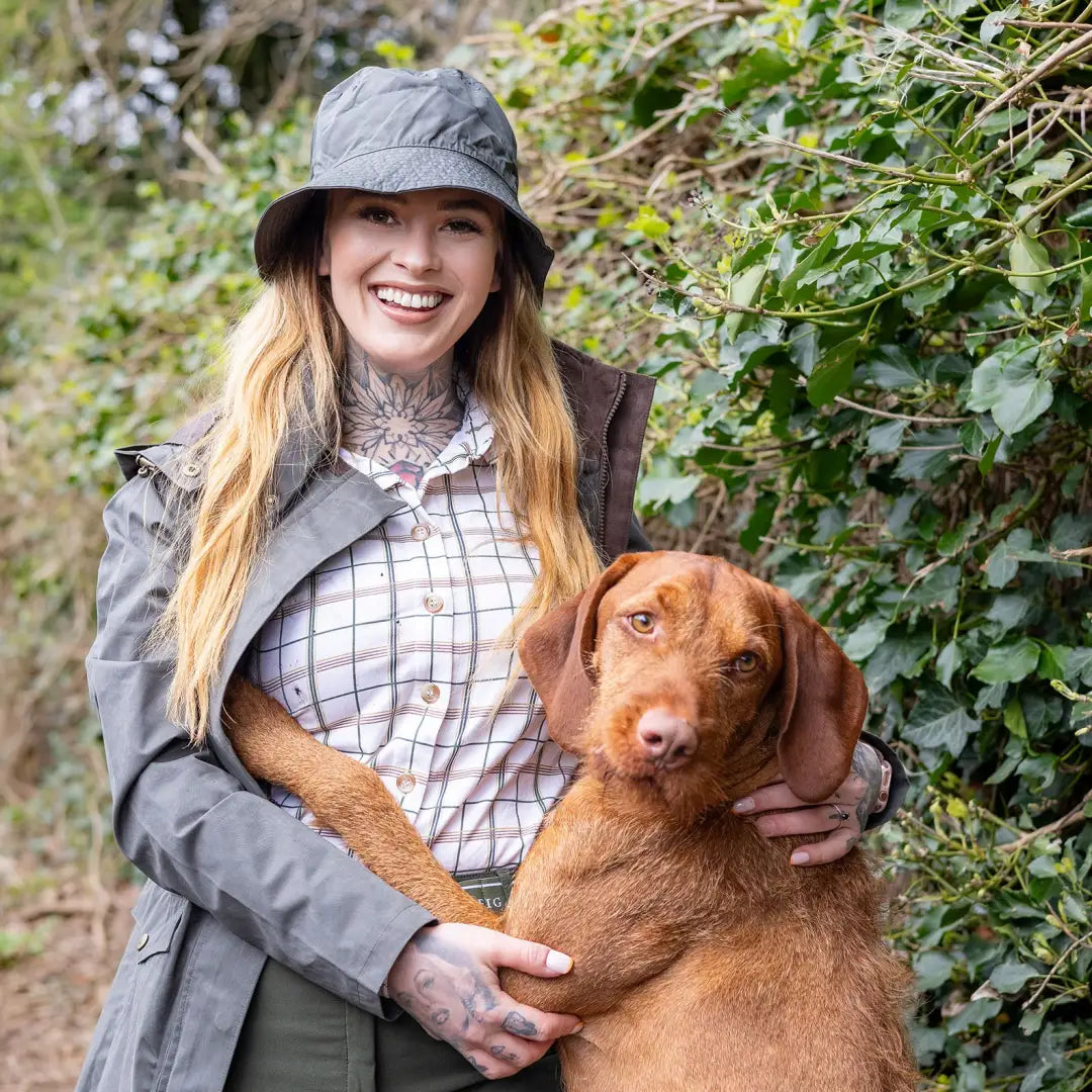 Woman enjoying outdoors with a brown dog in a Forest Victoria Waterproof Hat