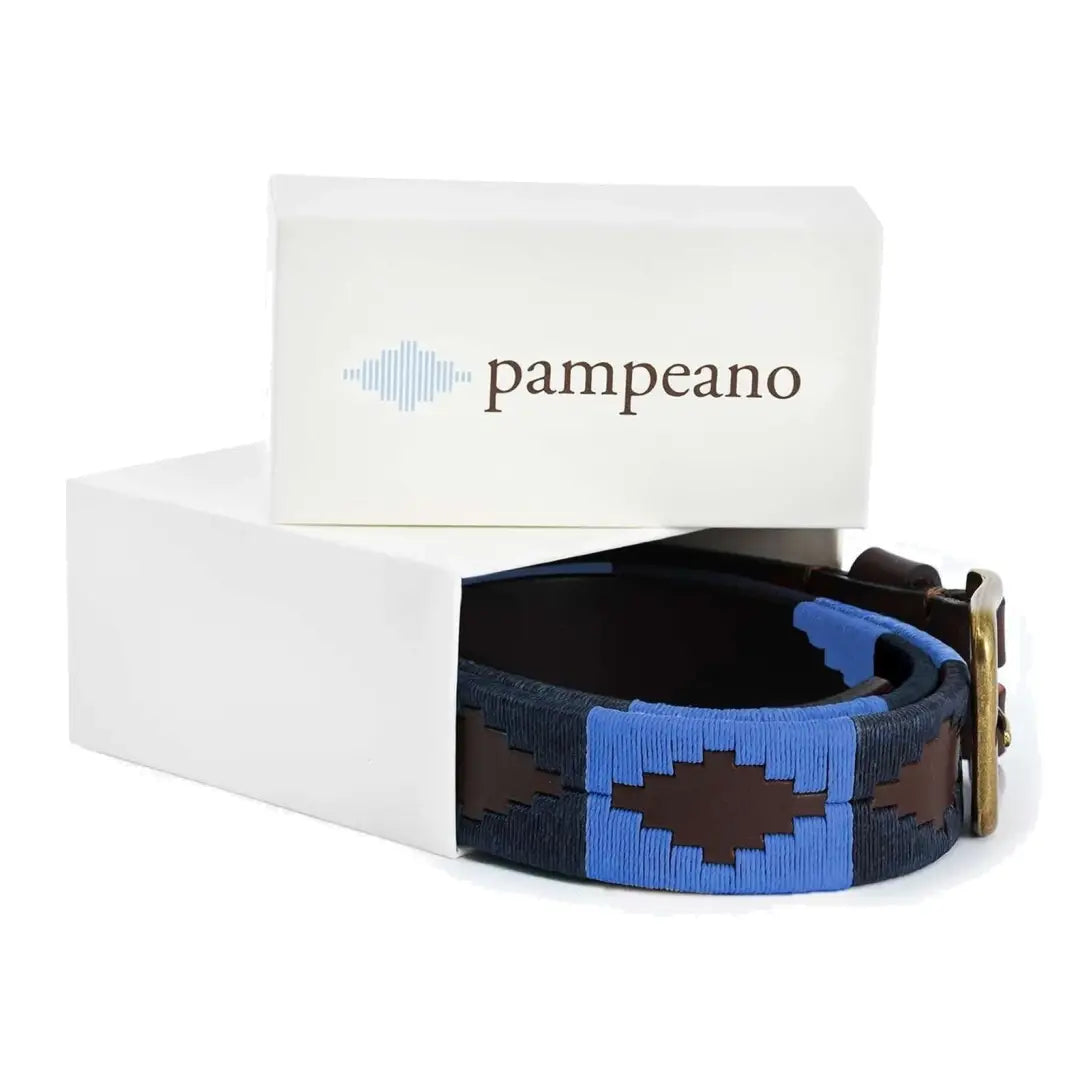 Leather Azules Polo Belt with blue and brown geometric embroidery next to Pampeano box