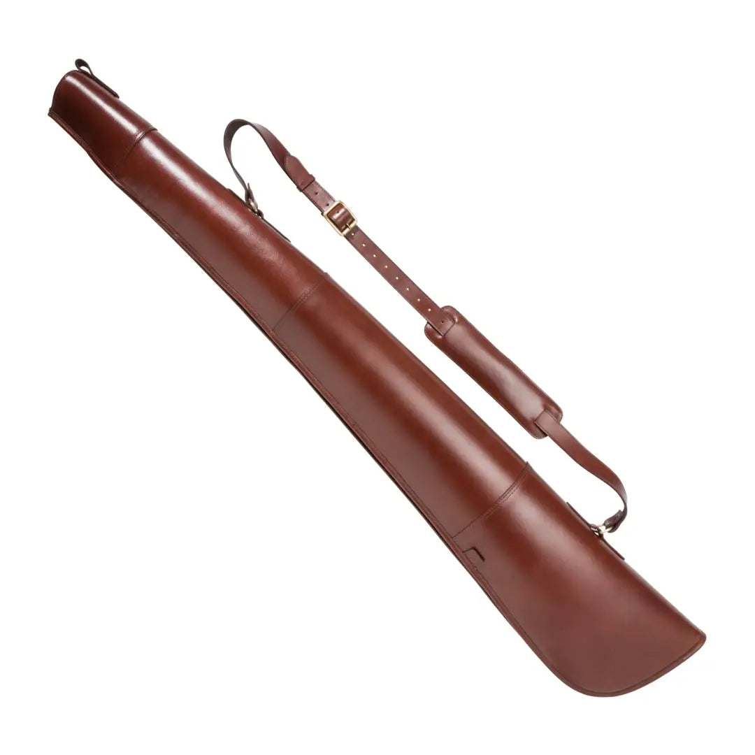 Brown leather shotgun slip with shoulder strap, perfect for securely carrying your firearm