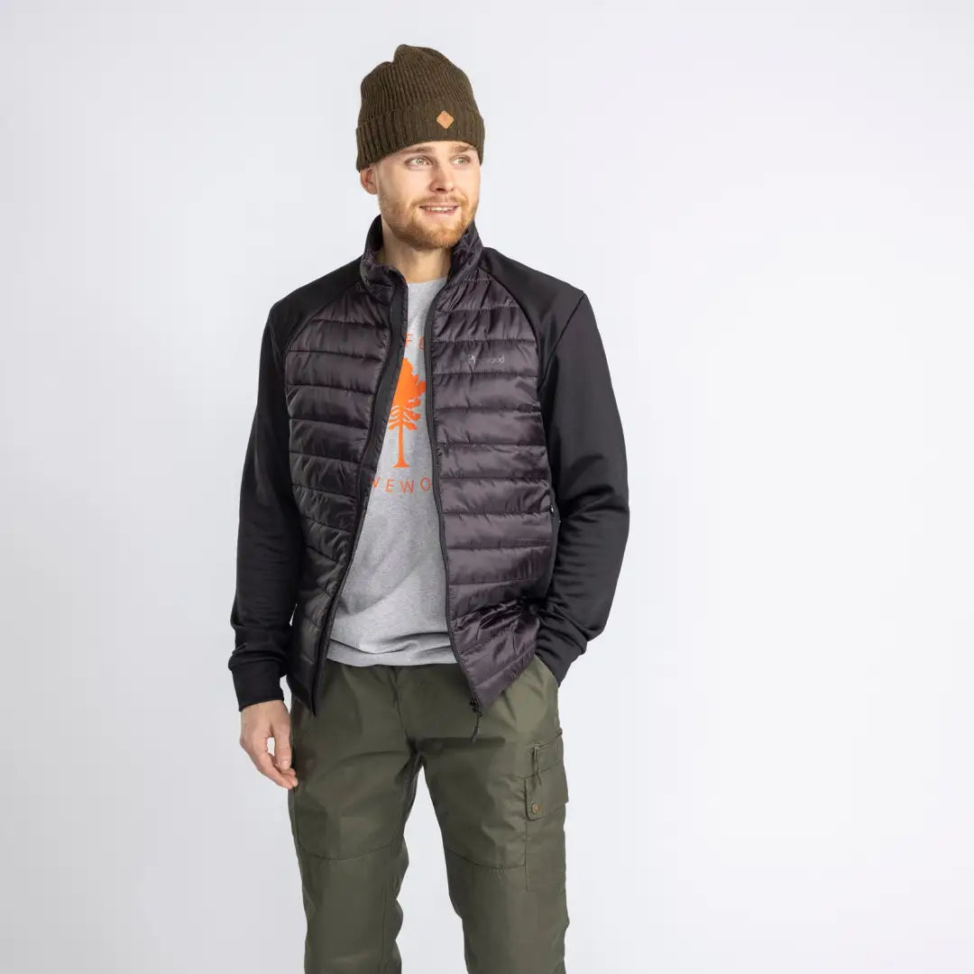 Man in black quilted vest over gray shirt and green pants for Pinewood Power Fleece jacket