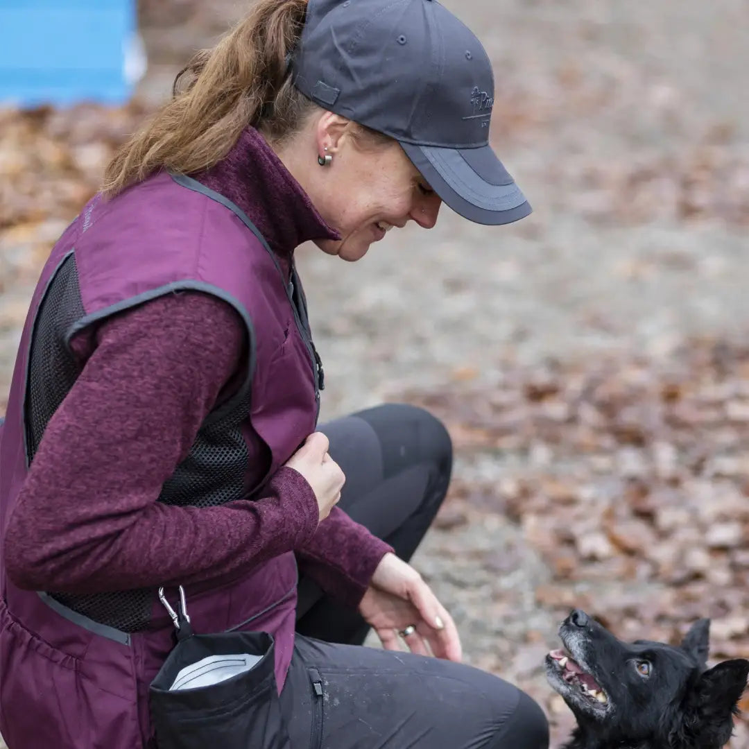 Person enjoying the outdoors with a small black dog in a Pinewood Ladies Dog Sport Vest