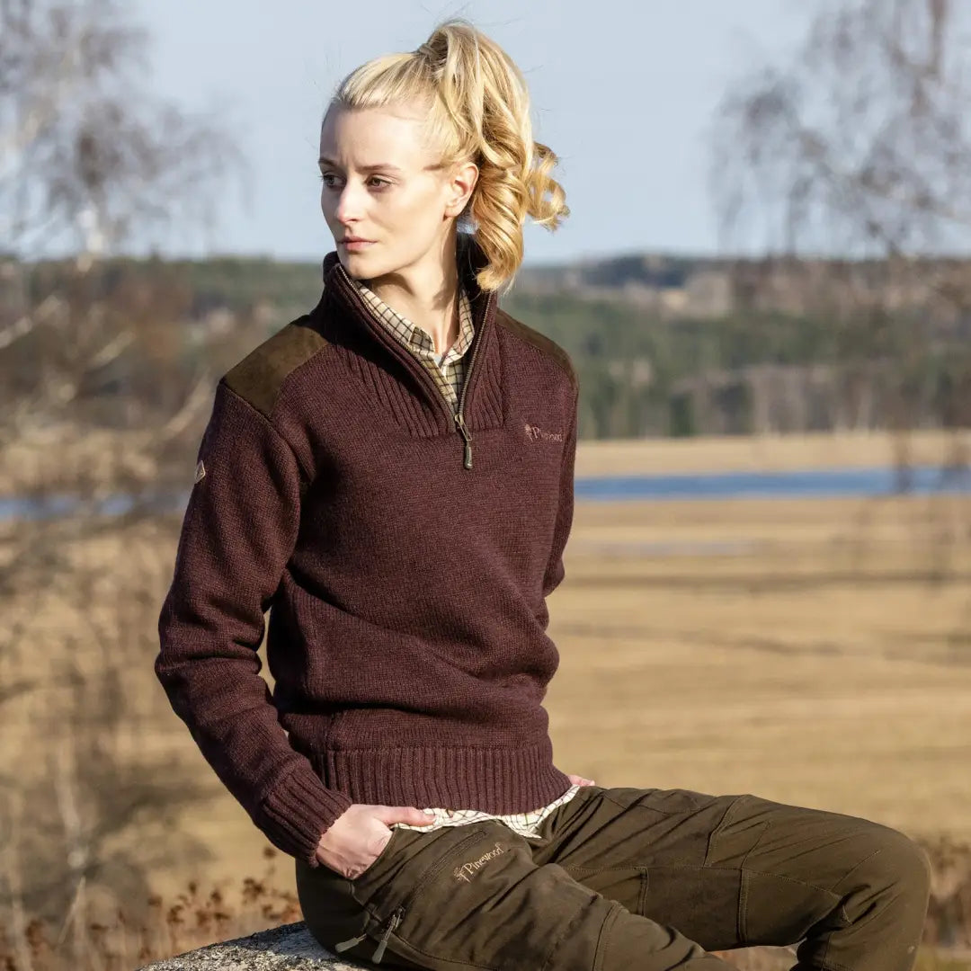 Woman with blonde hair in a brown Pinewood Ladies Hurricane Sweater and olive pants