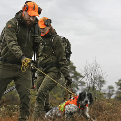 Two hunters in green Pinewood Retriever Active Hunting Jackets with a dog on a leash