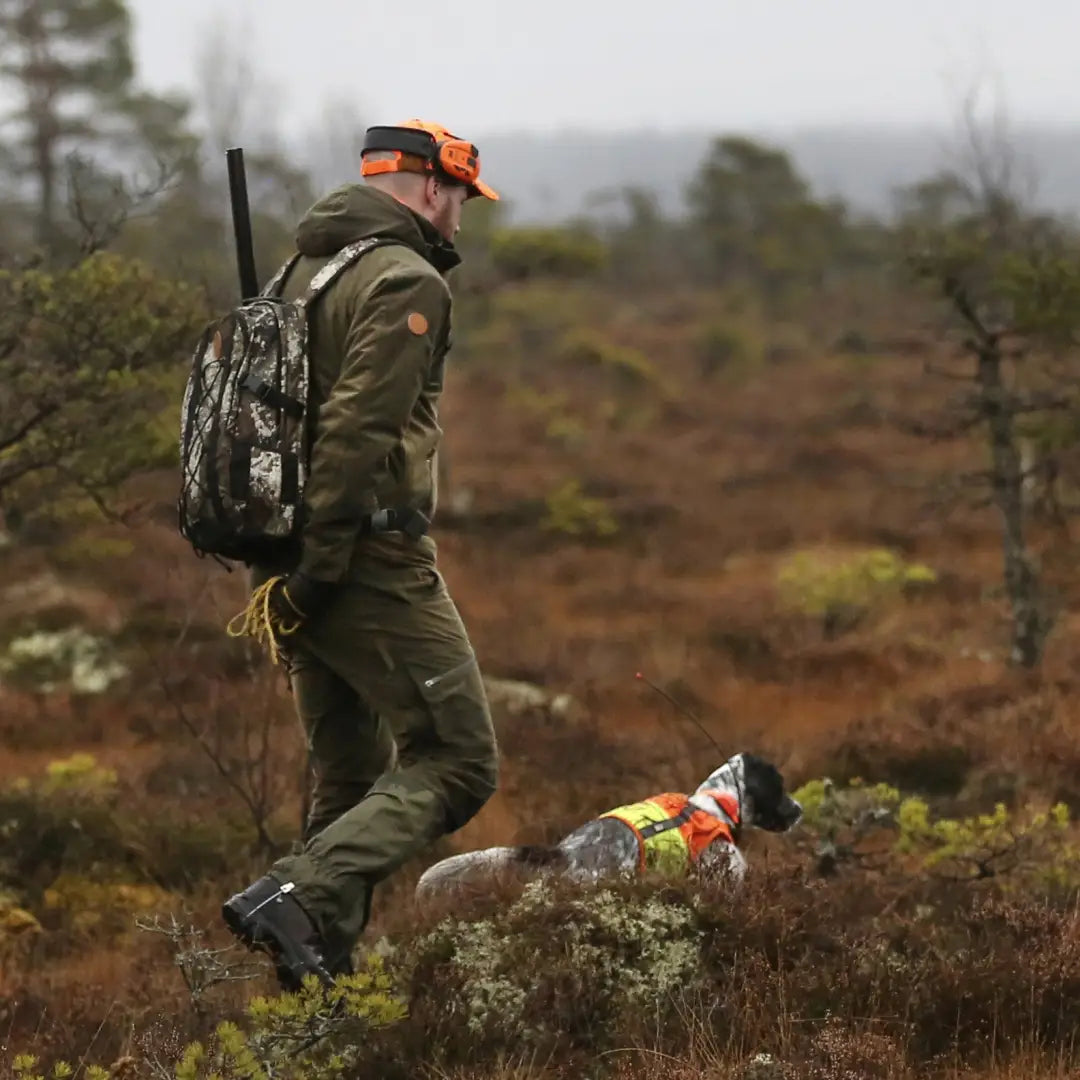 Hunter and dog joyfully exploring fields in Pinewood Retriever Active Hunting Trousers