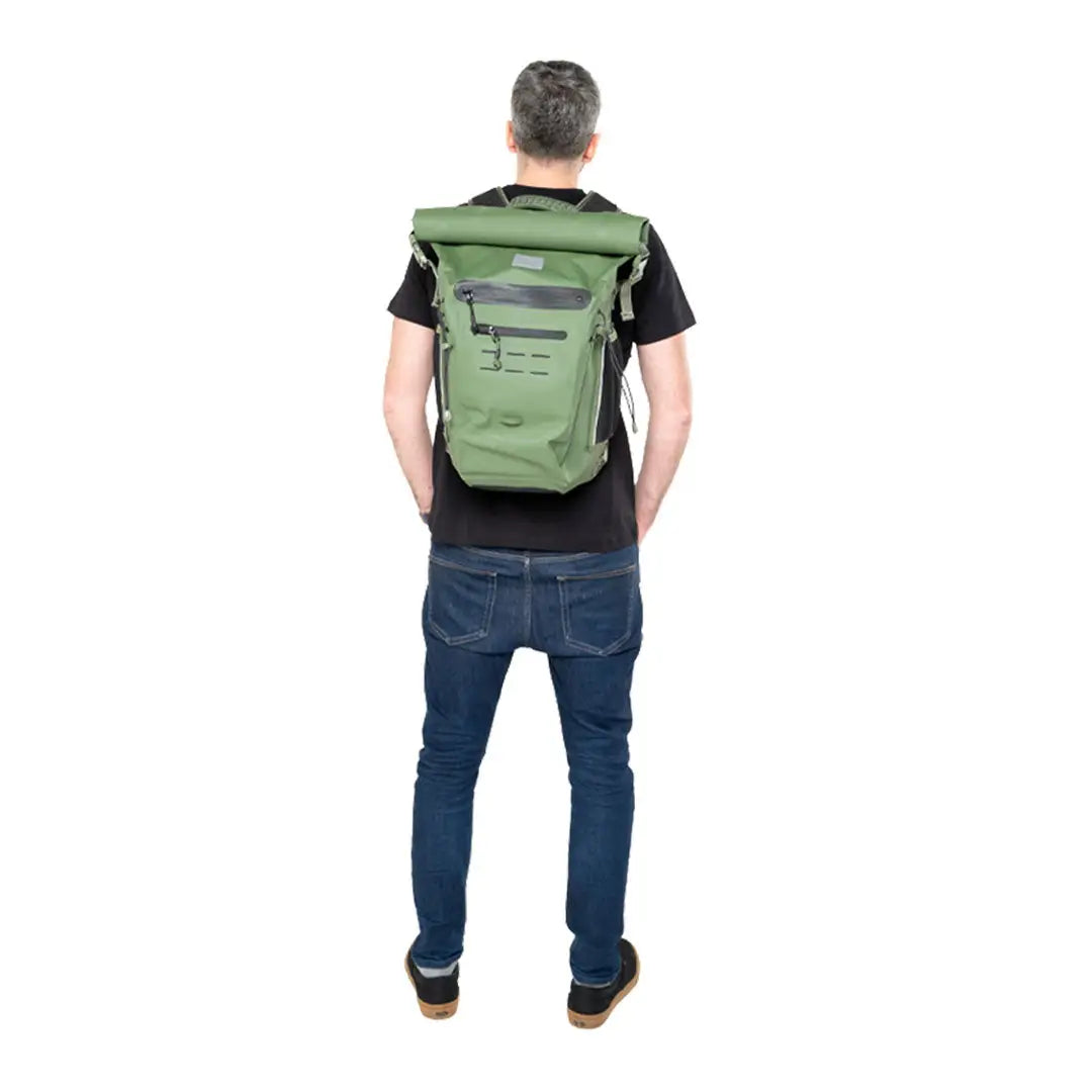 Person wearing a Green Adventure Waterproof Backpack for outdoor activities