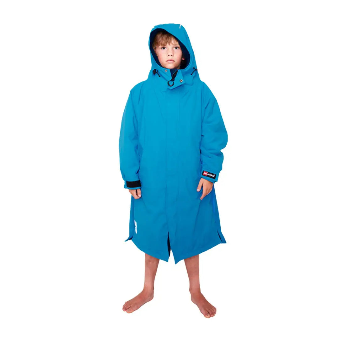 Bright blue Kids Dry Pro Robe on a child, perfect for post-swim comfort