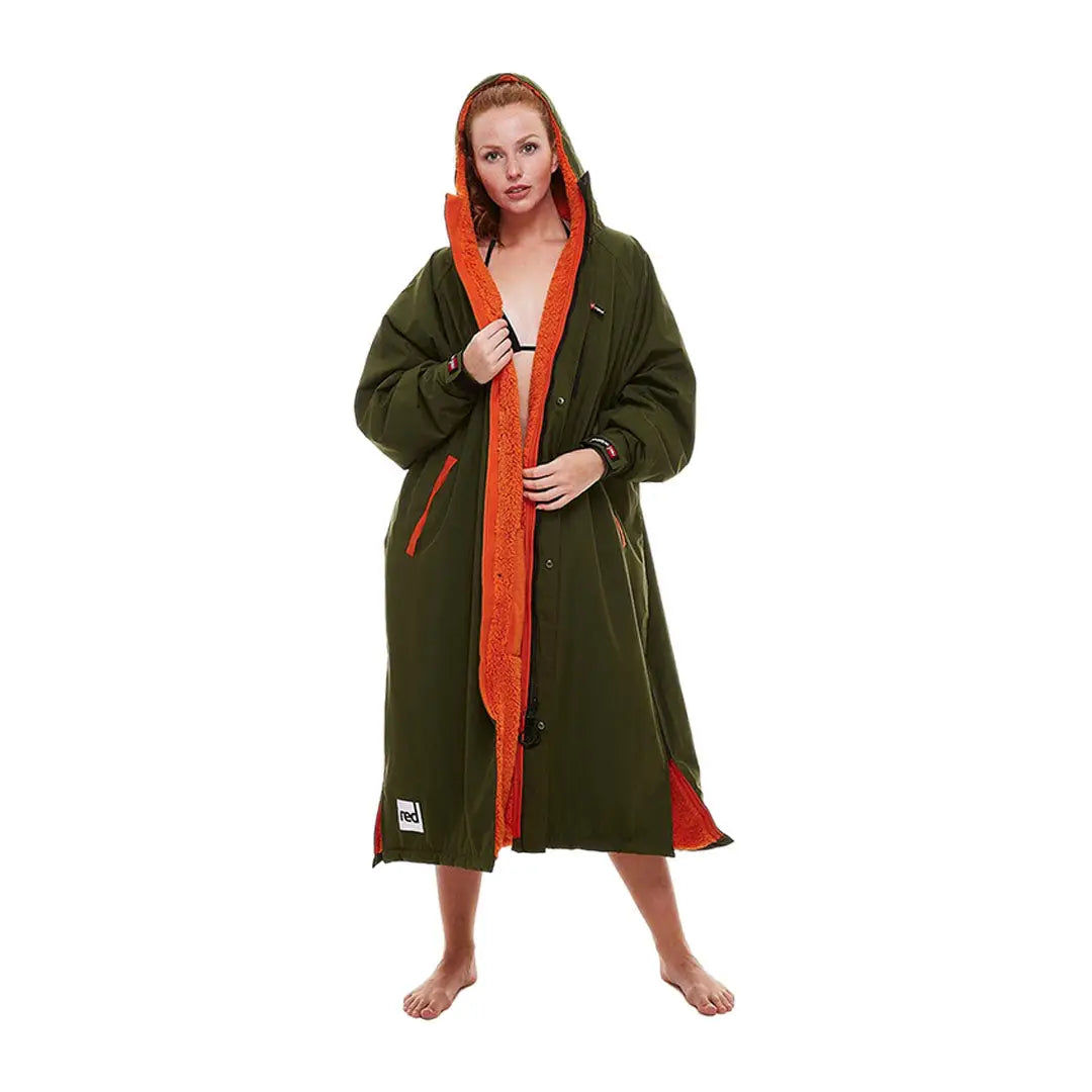 Woman in an Olive Green Changing Robe with Orange Lining from the Red Pro Change Jacket