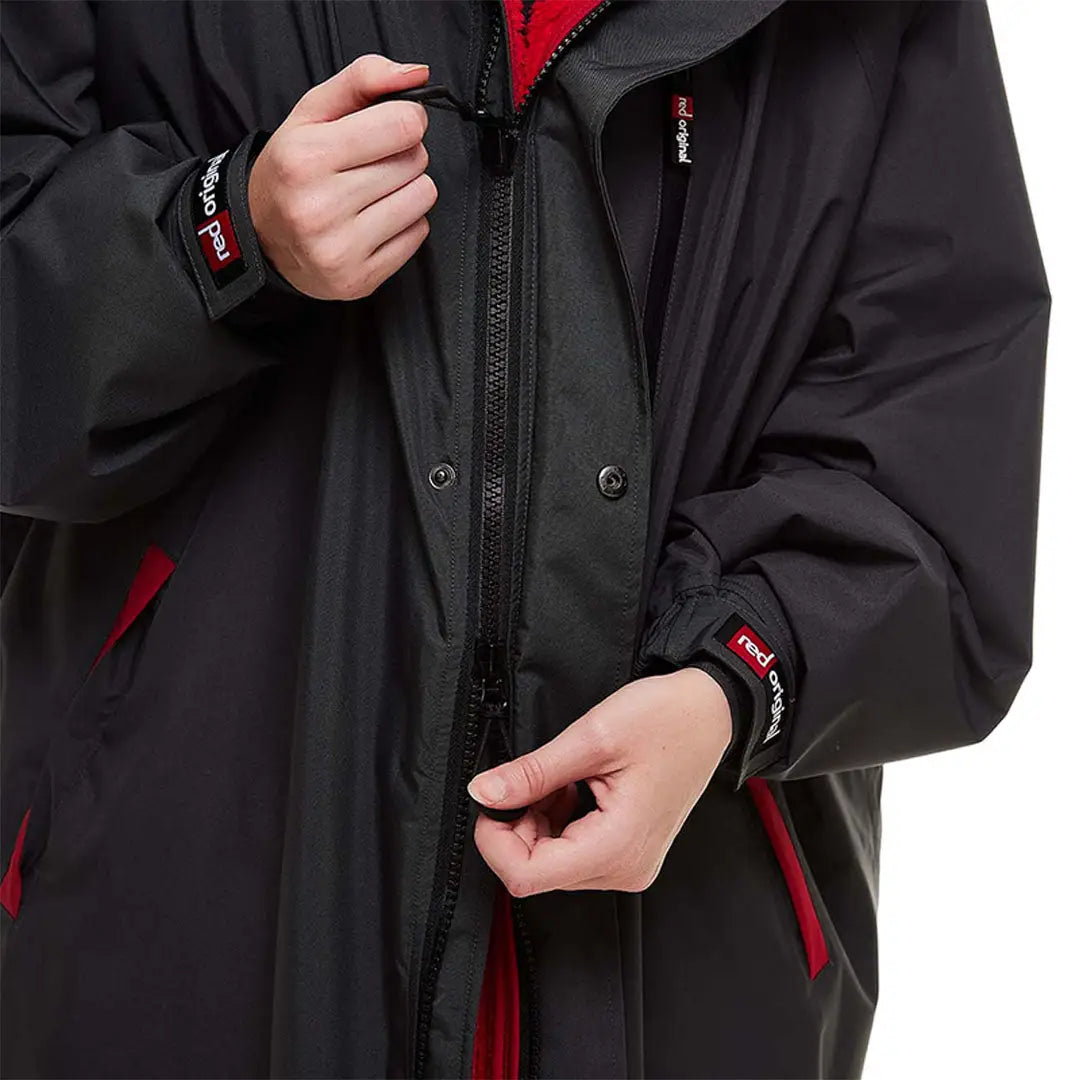 Black winter jacket with red accents and zippers, perfect for your Change Robe needs