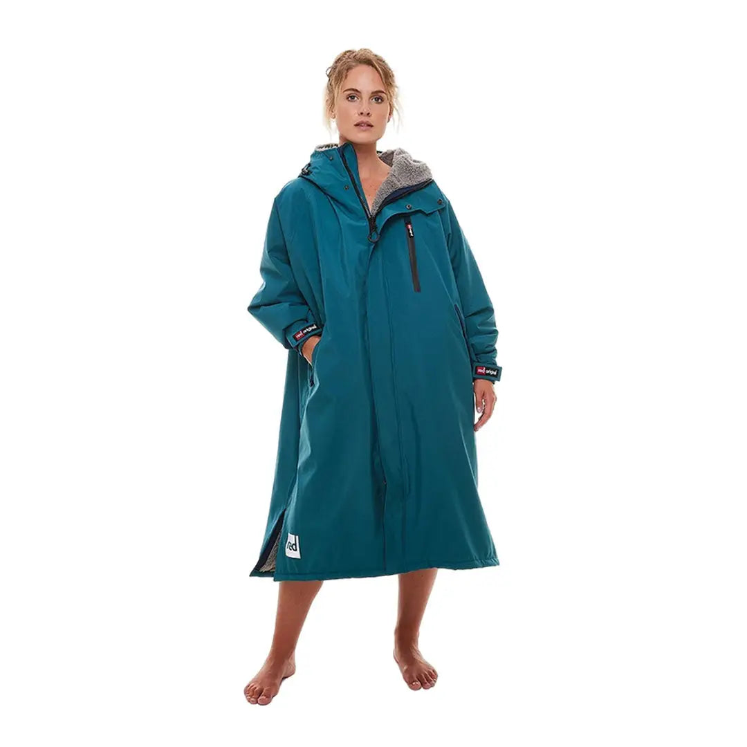 Teal waterproof changing robe on a woman, perfect for outdoor adventures in the Evo range