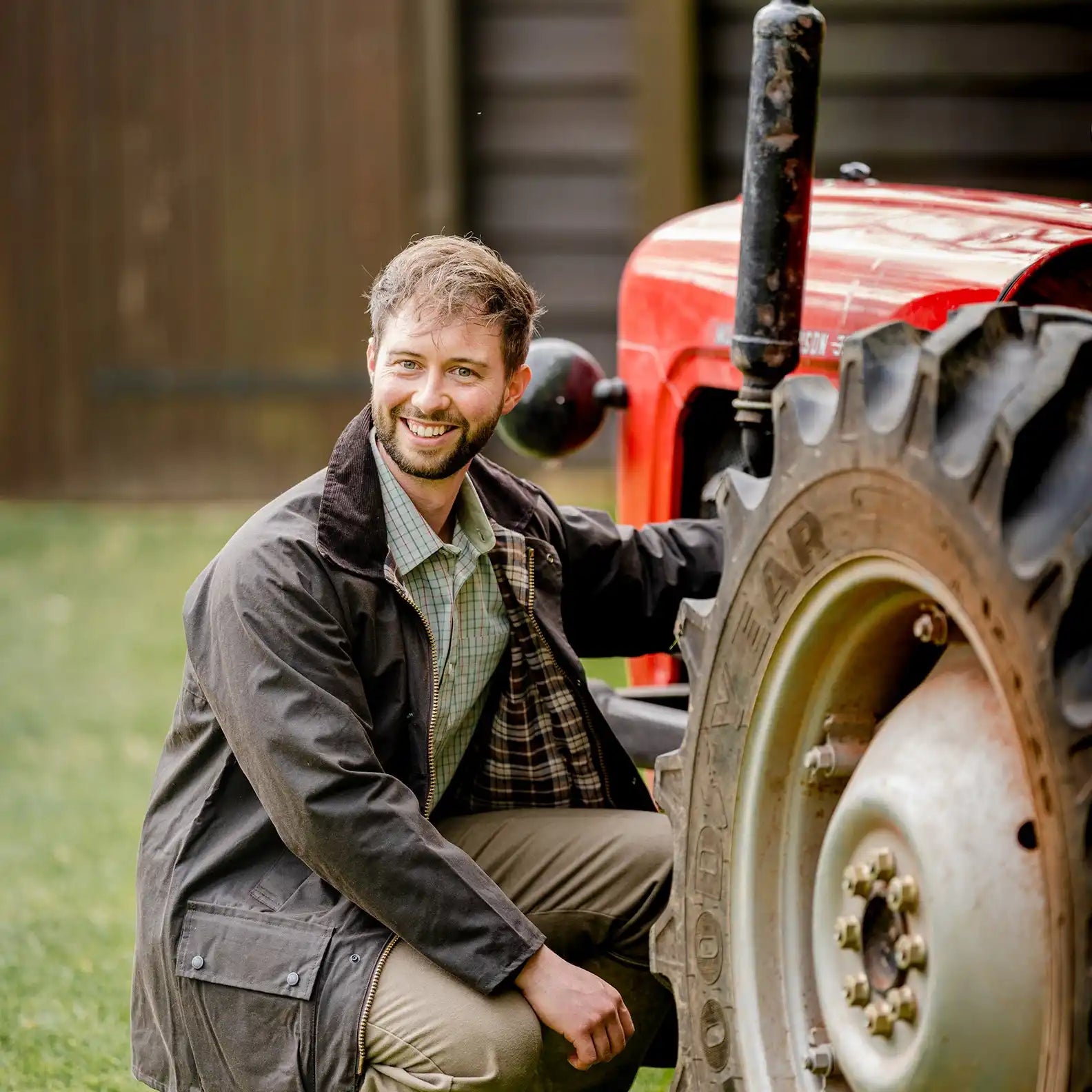 Red tractor with large tire.