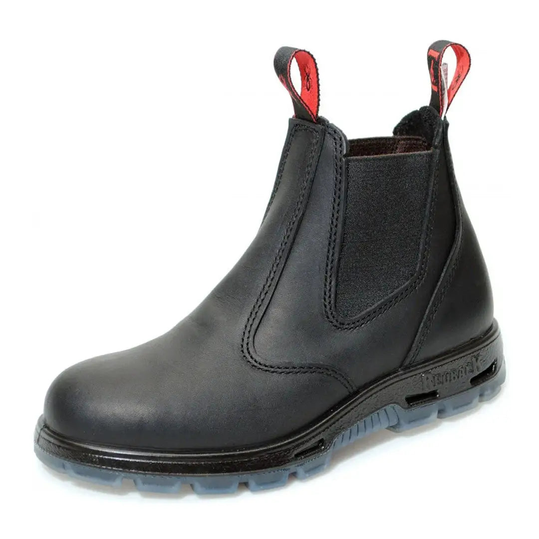 Black leather Chelsea-style Redback Boots with a red pull tab and transparent sole