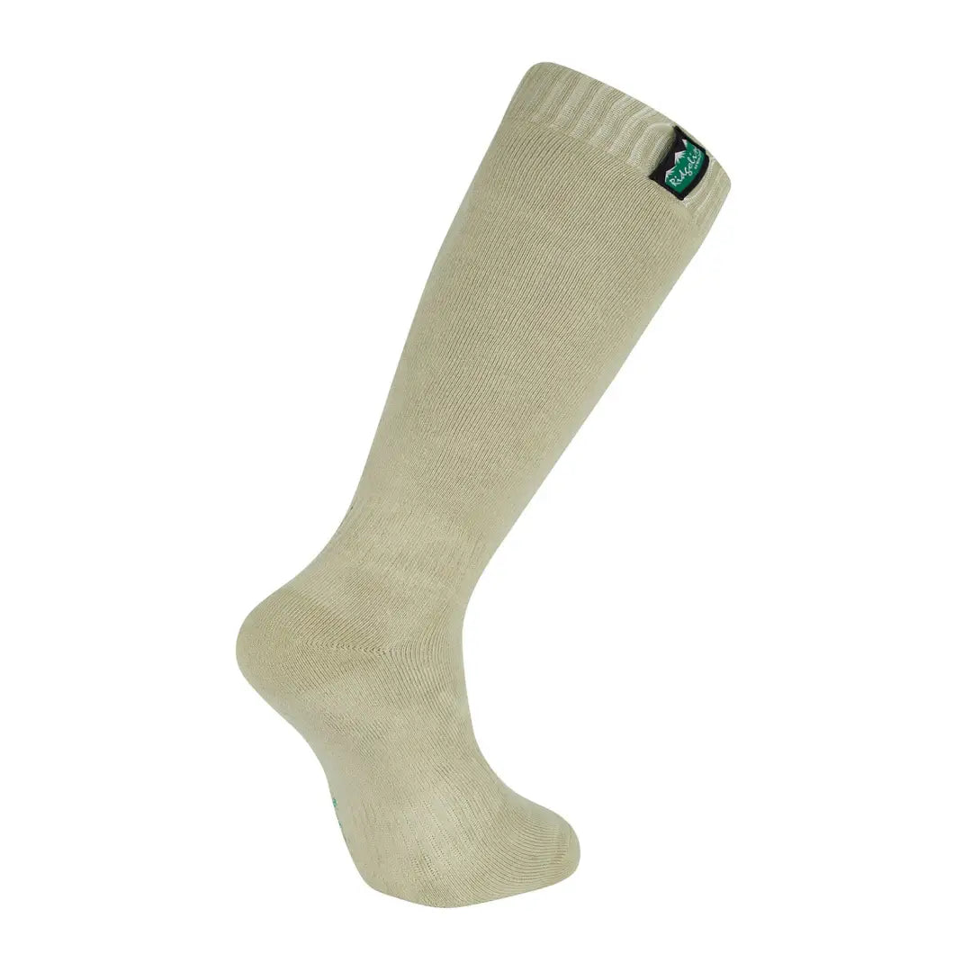 Beige knee-high cotton work sock with a small green label for Ridgeline style