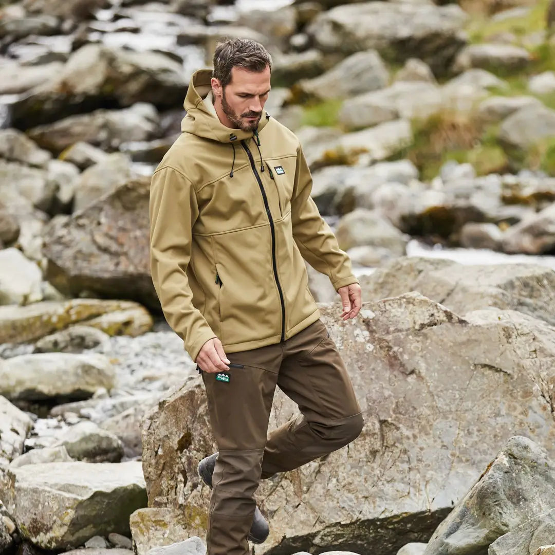 Man rocking a Ridgeline Gradient Jacket on rocky terrain in the British Isles