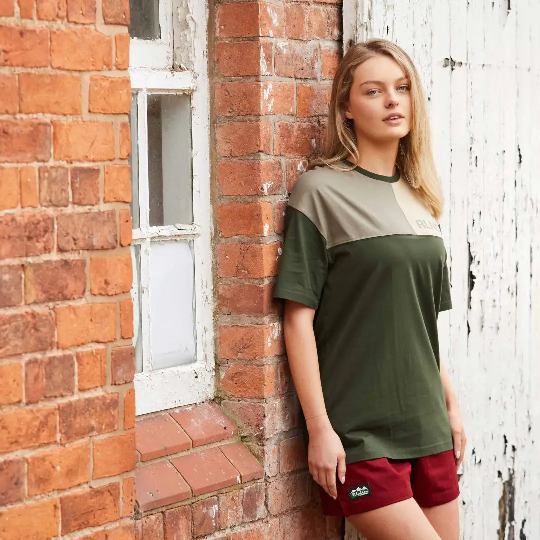 Woman in a color-blocked tee and burgundy shorts showcasing Ridgeline Hose Down Shorts outdoors