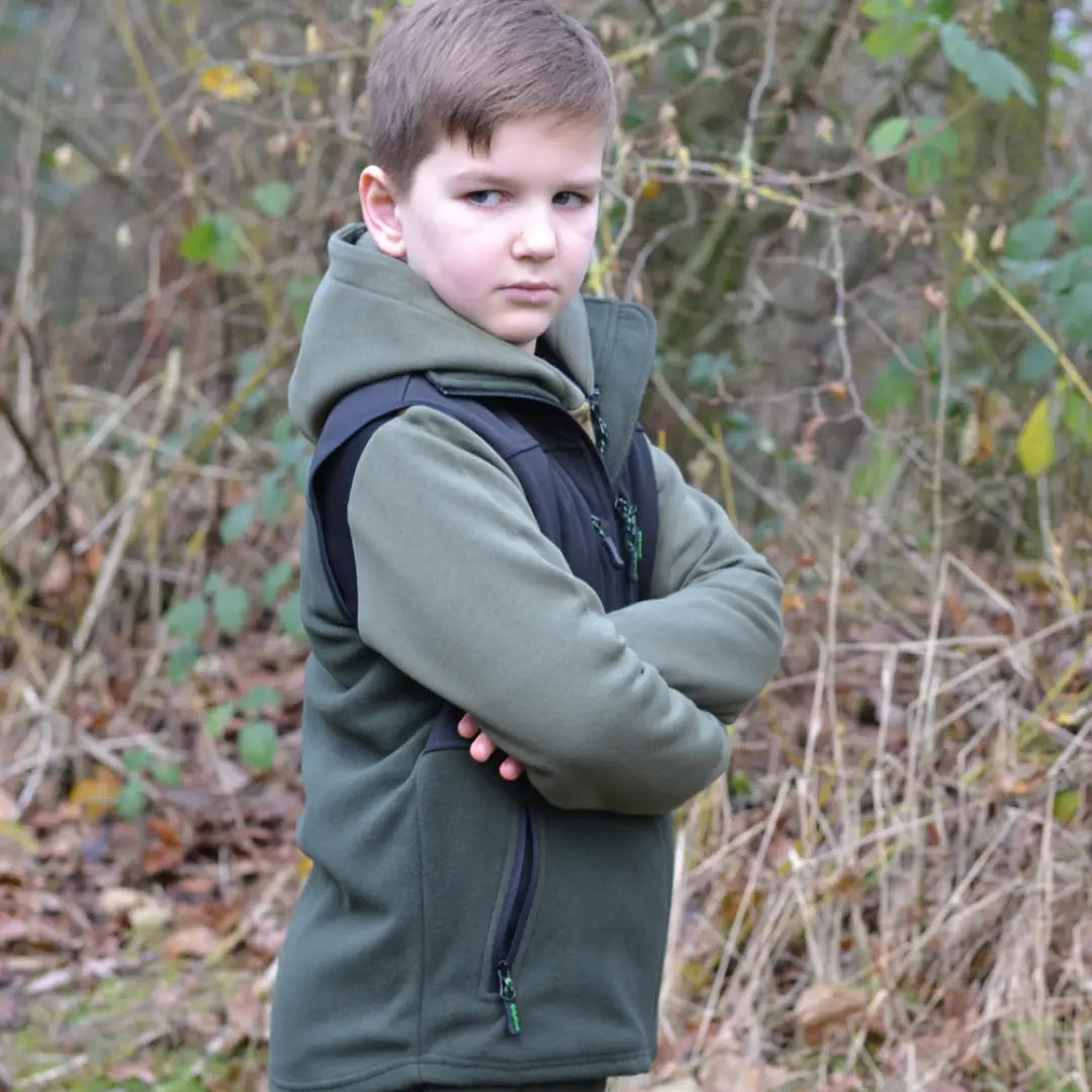 Young child in a green hooded jacket, a great kids piece from Ridgeline Kids Hybrid