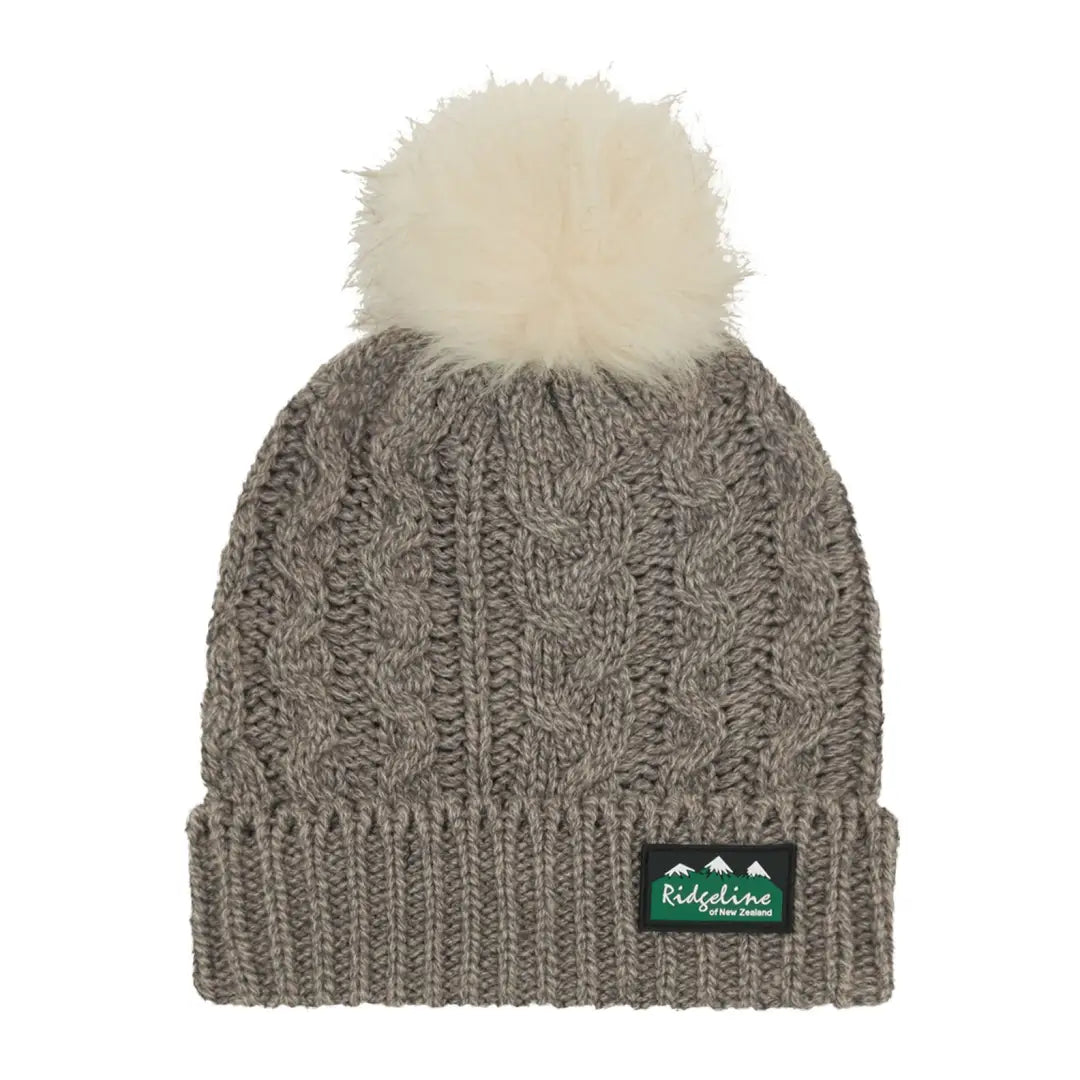 Gray Nordic Fleck Bobble Hat with a white pompom and green label stylishly cozy