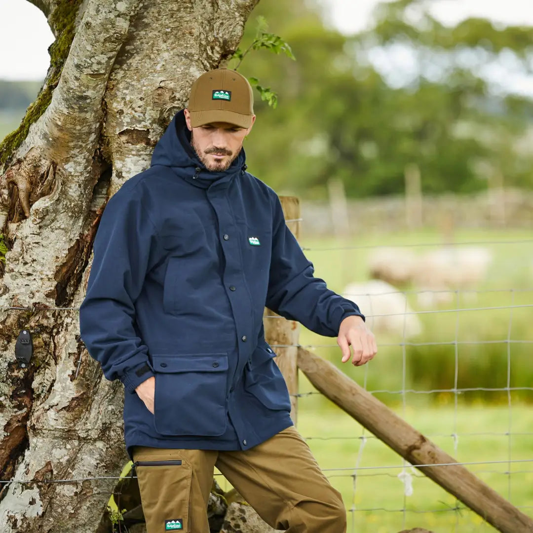 Man in navy blue jacket and tan cap showing off Ridgeline Torrent Euro III style