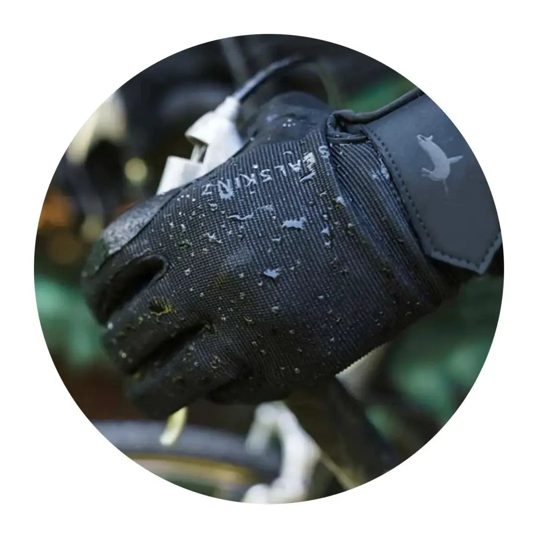 Black waterproof Sealskinz Harling Glove with water droplets on the surface