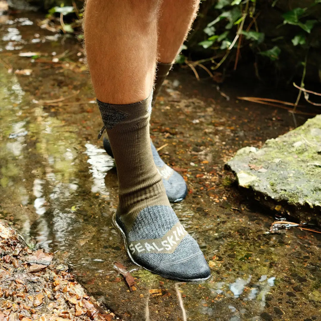 Sock-covered foot in a gray hiking shoe, perfect for outdoors and country clothing adventures