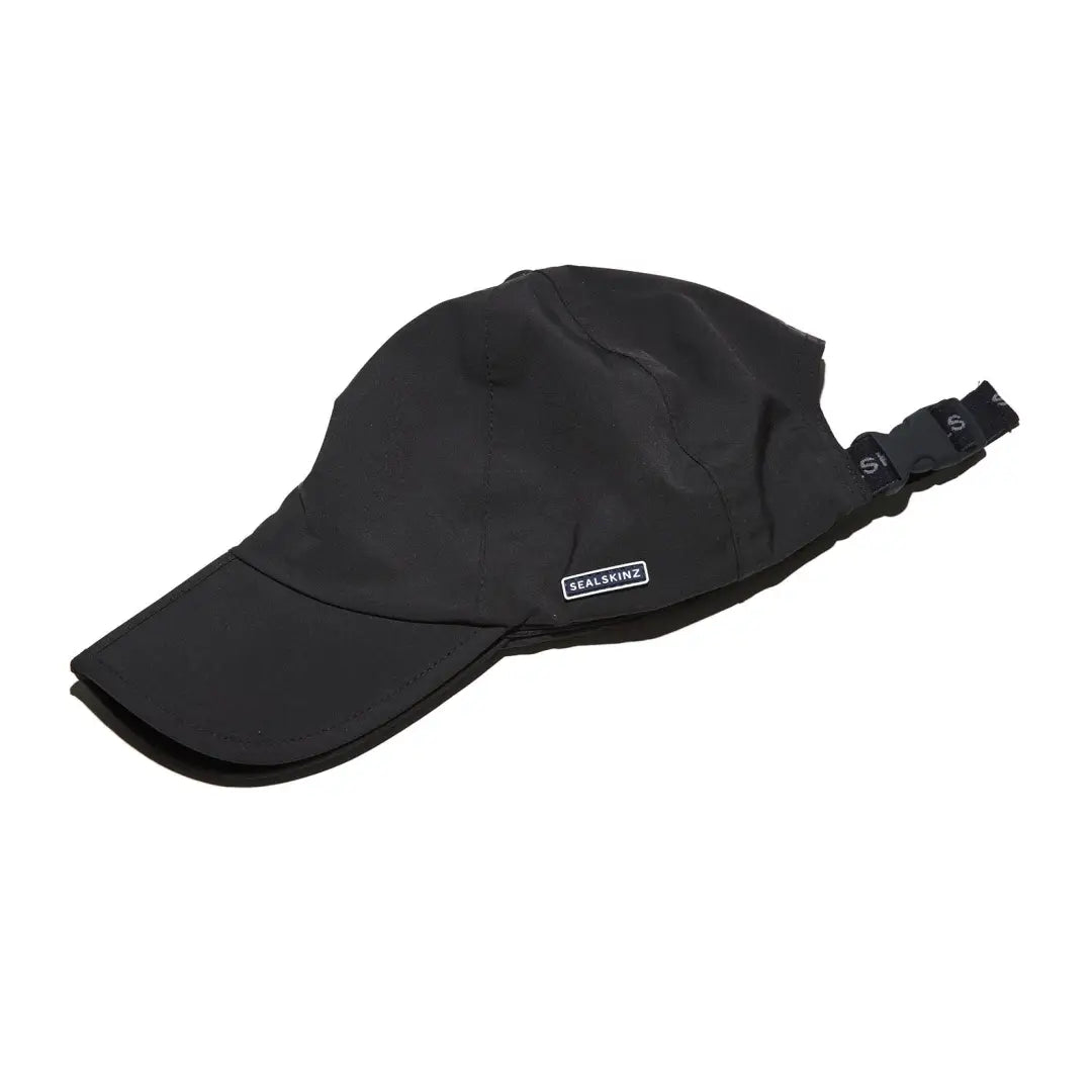 Black Sealskinz Salle Cap with adjustable strap, perfect for country clothing and hunting