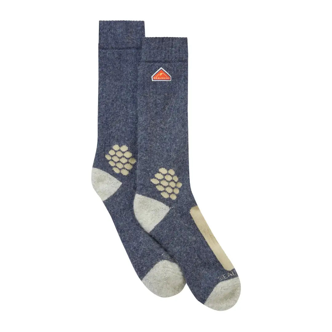 Blue-gray hiking socks with beige accents and an orange logo, made from recycled wool