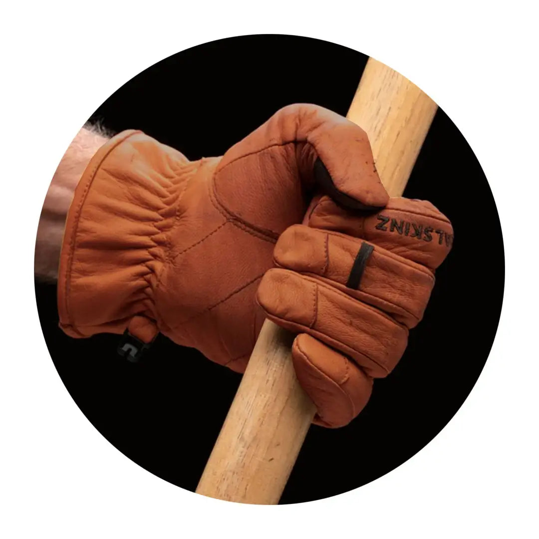 Leather work glove gripping wooden handle, perfect for waterproof cold weather tasks