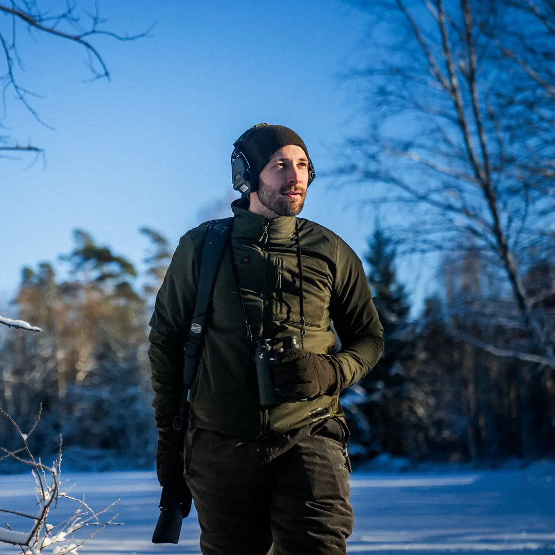 Man in Seeland Celsius Heat Jacket with binoculars enjoying the outdoors