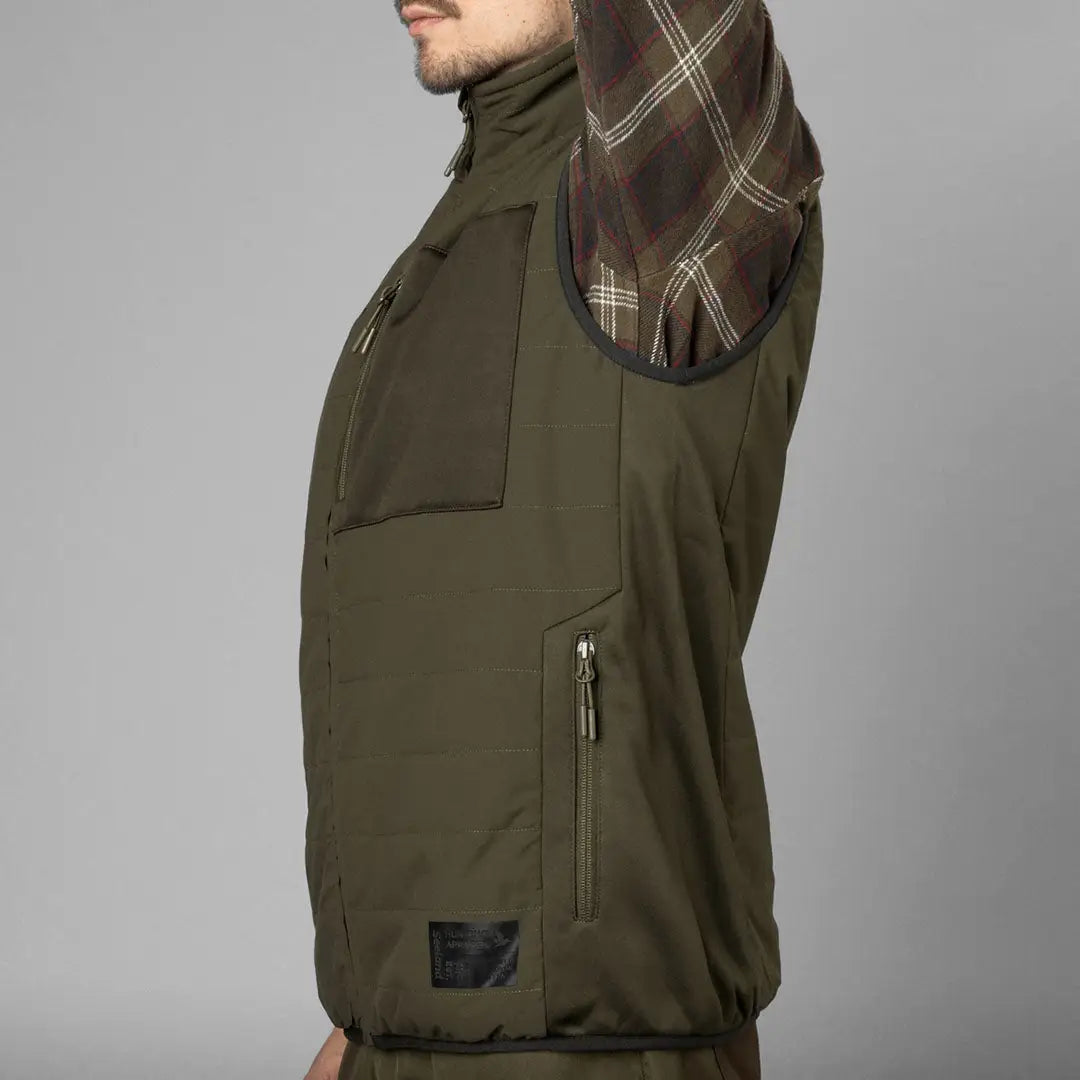 Olive green Celsius Heat Waistcoat featuring pockets and zippers for outdoor adventures